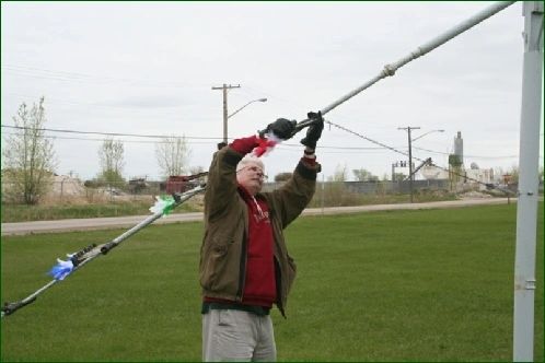 An archer shooting an arrow up at the pole