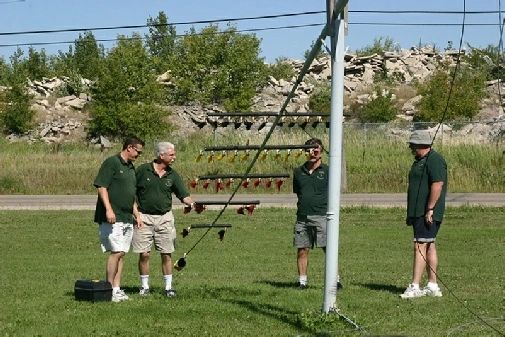 Club members standing beside the pole with the fork lowered