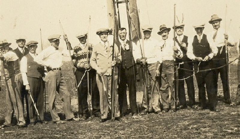 Archers from the Ste. Rose-Ste Amelie club standing with their bows and poles