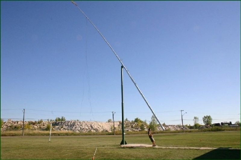 The tall pole bending at an angle as the fork is lowered to the ground